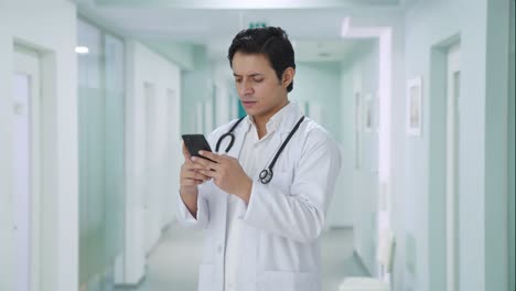 angry indian doctor chatting on phone