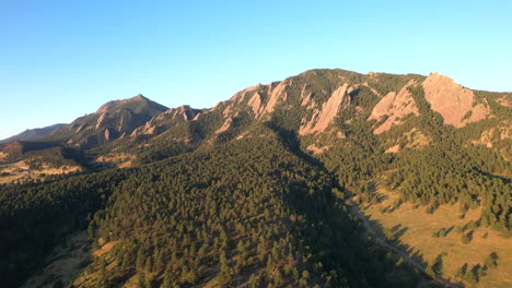 Boulder-Flatirons-at-sunrise,-near-CU-Boulder-and-chautauqua-park-with-biking-and-hiking-trail