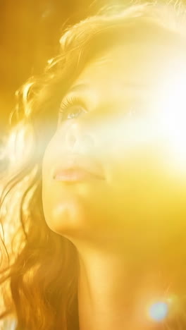a woman with long hair is looking up at the camera. the image has a warm, inviting mood, and the woman's expression suggests that she is happy or excited