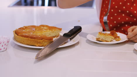 Mother-and-daughter-having-tart-in-kitchen