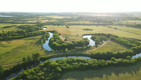 countryside. a wide riverbed, flowing between fields and forests