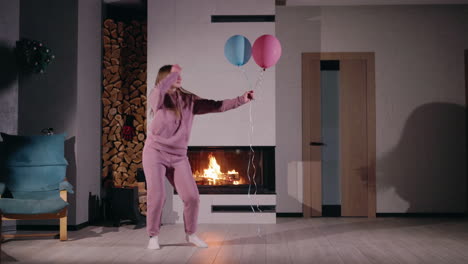 woman jumping with balloons in cozy living room