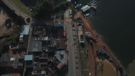 Drone-aerial-view-of-the-city-in-Guatapé-revealing-the-beautiful-lake-at-El-Peñón,-Colombia