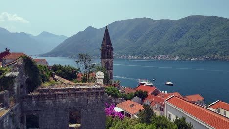 flyover old stone building ruin toward perast waterfront, montenegro