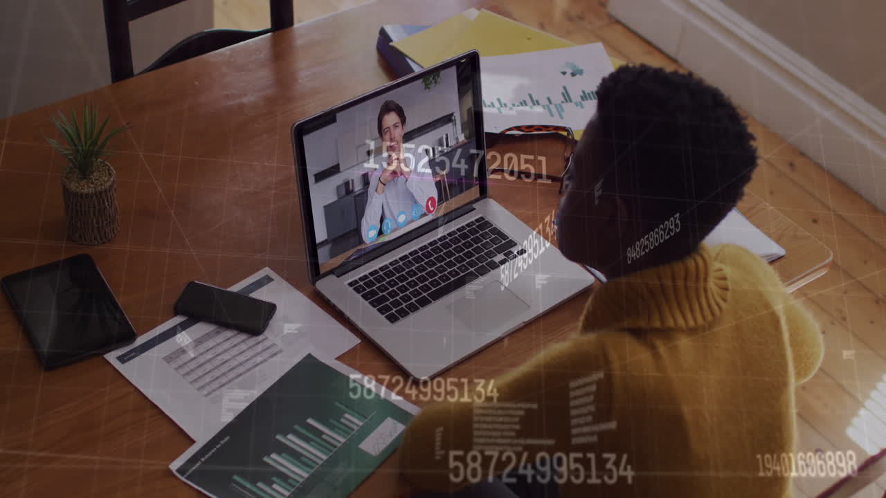 Animation of numbers changing over woman using laptop on video call in background