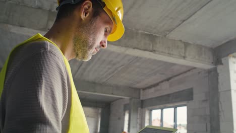 low angle footage of caucasian engineer browsing building project on a digital tablet.