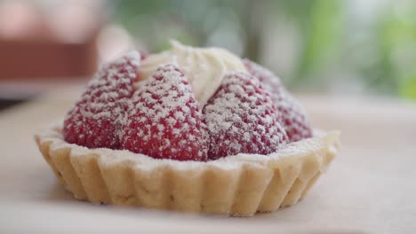 close-up of a delicious strawberry tart with whipped cream