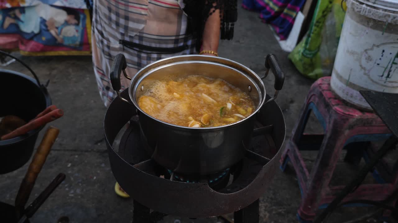 Street Food Vendor Cooking in a Pot