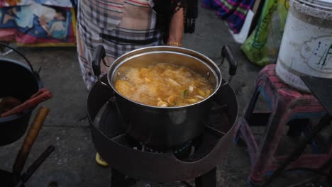 street food vendor cooking in a pot