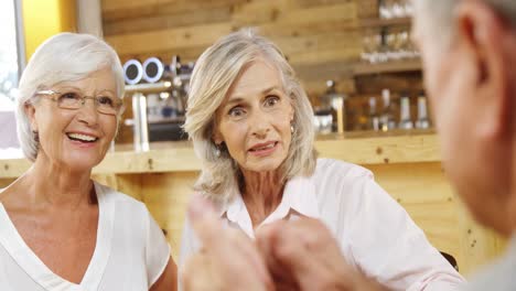 Senior-friends-talking-in-the-cafe-4k