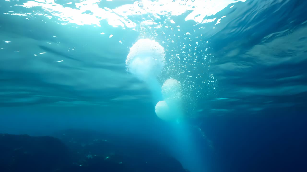 A beautiful blue ocean with a white bubble rising from the water. The bubble is surrounded by a clear blue sky, creating a serene and peaceful atmosphere. Concept of calmness and tranquility