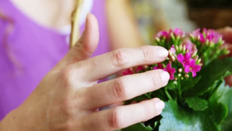 female florist arraigning flower in wicker basket