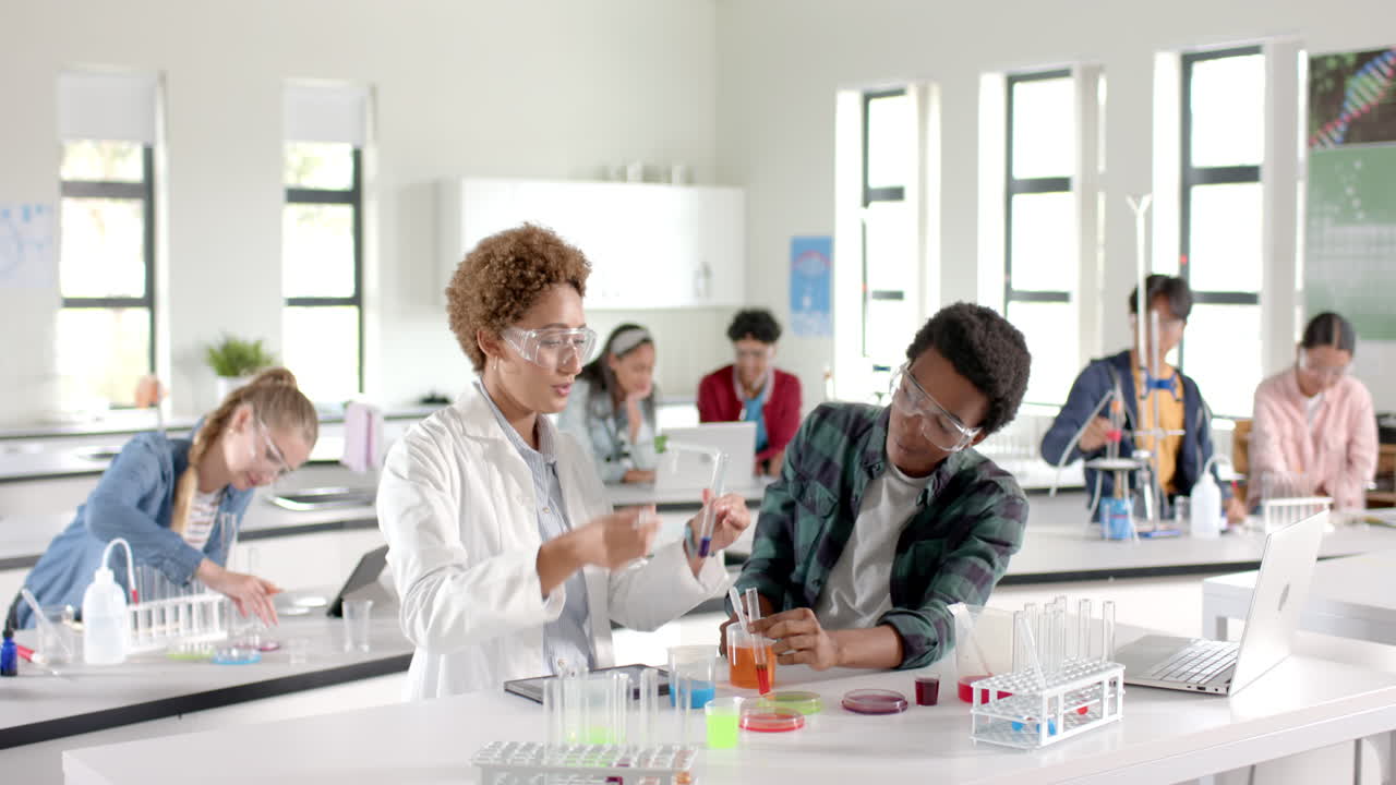 In high school laboratory, students conducting experiment with test tubes and beakers