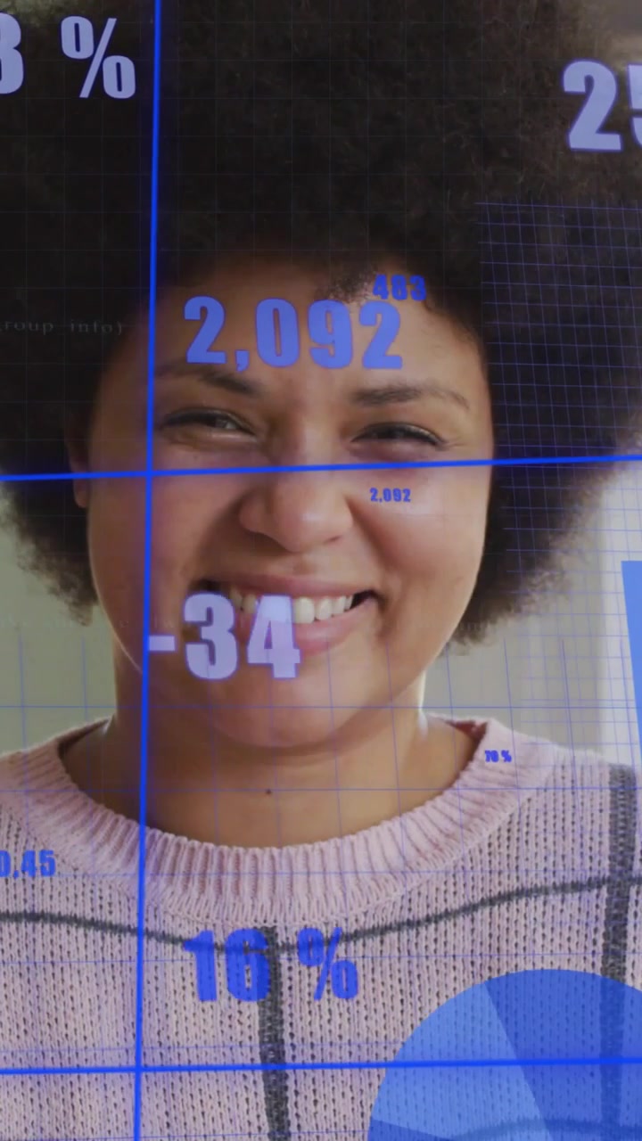 Vertical video: Mid-adult woman reacting to AR overlay, smiling as tech charts update across face