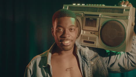 black man vibing with retro ghetto blaster on shoulder