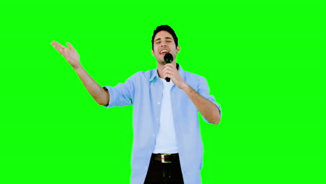 Man-singing-into-microphone-on-green-screen