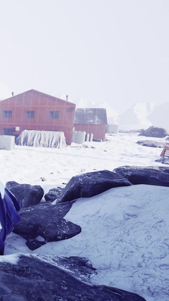 Snowy landscape with small cabins in a remote location during winter time