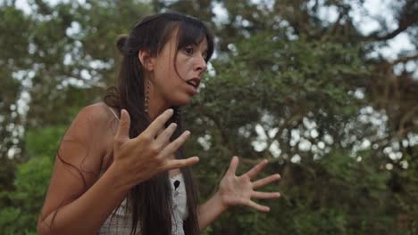 a woman with black hair and white dress is singing