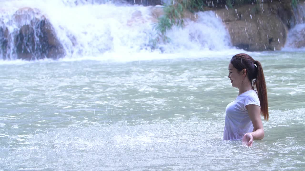 Asian Woman Swimming And Happy With Waterfall
