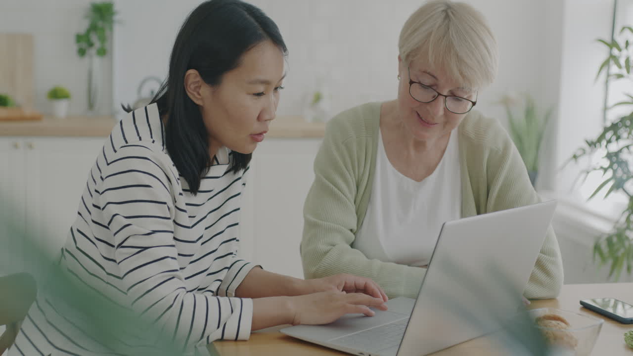 Daughter and Mother Using Laptop Together
