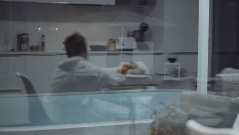 boy having lunch view through the glass