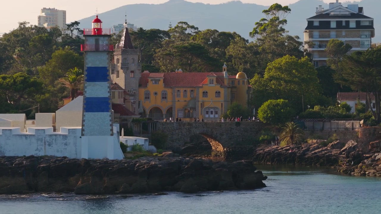 Faro di Santa Marta con il Museo Condes de Castro Guimarães che si affaccia sulla costa atlantica a Cascais, Portogallo, durante l'ora d'oro