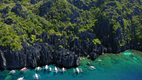 aerial view of hidden lagoon, with many spider boats parked, coron, palawan, philippines