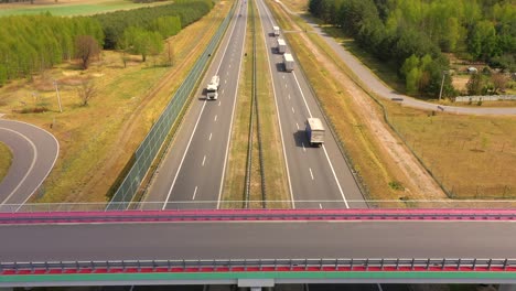 traffic of cars and trucks on the freeway in summer day - top view shot