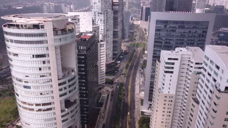 Aerial-shot-of-corporate-buildings-on-Santa-Fe-Avenue,-next-to-La-Mexicana-Park-in-Mexico-City