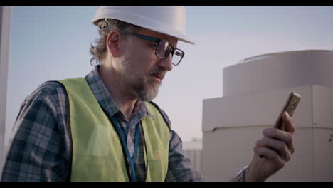 engineer checking equipment on rooftop
