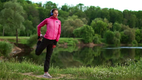 the girl warms up early in the morning before training preparing for a run in the sun