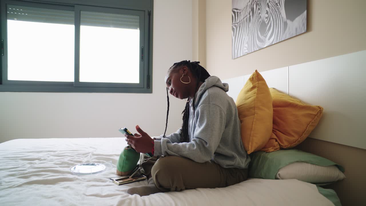 Woman applying makeup in bedroom