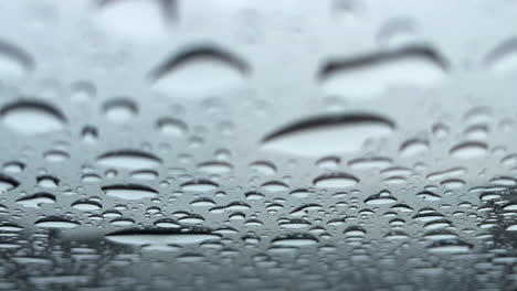 close up of rain drops on a glass roof