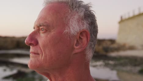 Side-view-senior-man-at-beach