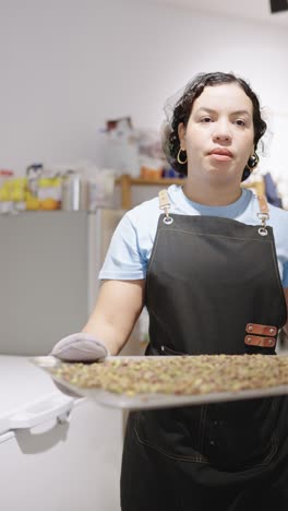 woman holding tray of food in kitchen