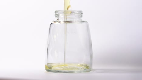 slow motion close up egg whites pouring in jar yoke missing