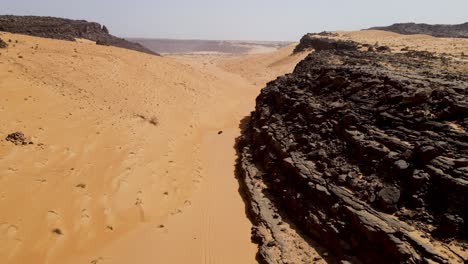 atar mountain cliffs near terjit oasis in mauritania sahara desert, africa - aerial drone flight