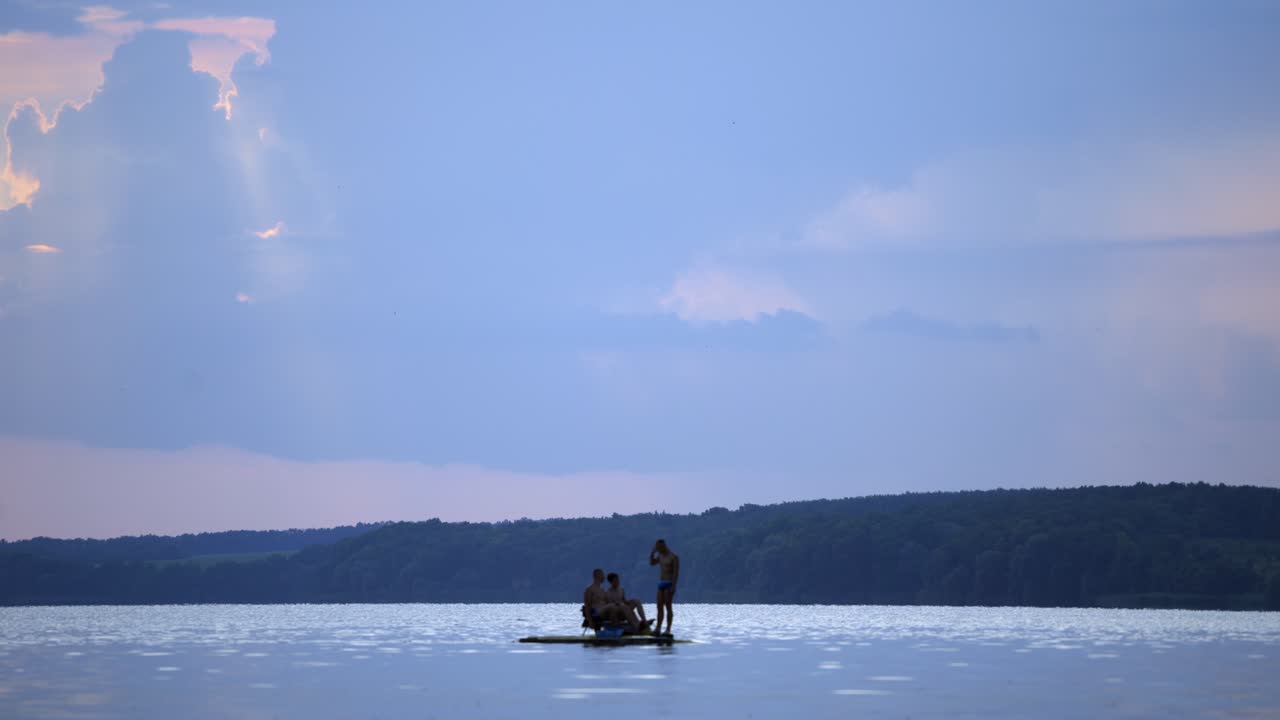 Catamaran sailing on the river. People swim in a catamaran for walking along the river
