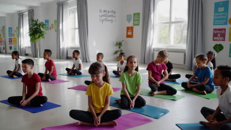 children practicing yoga and mindfulness in a classroom