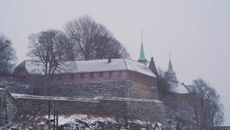 view of outside walls of akershus fortress on snow winters day in oslo