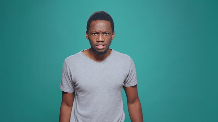 Violent furious man expressing anger and aggression in studio