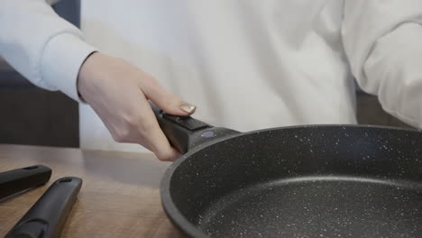 woman holding a black frying pan