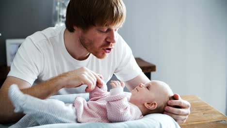Serious-dad-talking-to-baby-daughter