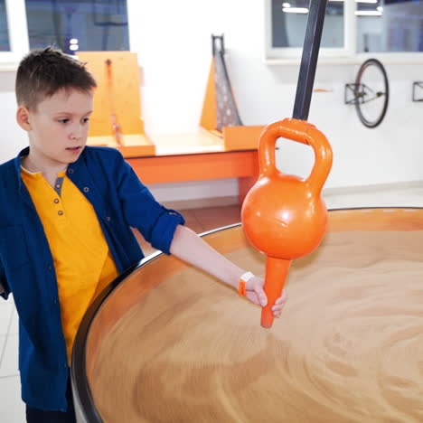 schoolboy makes practical experiments at a science centre. science museum