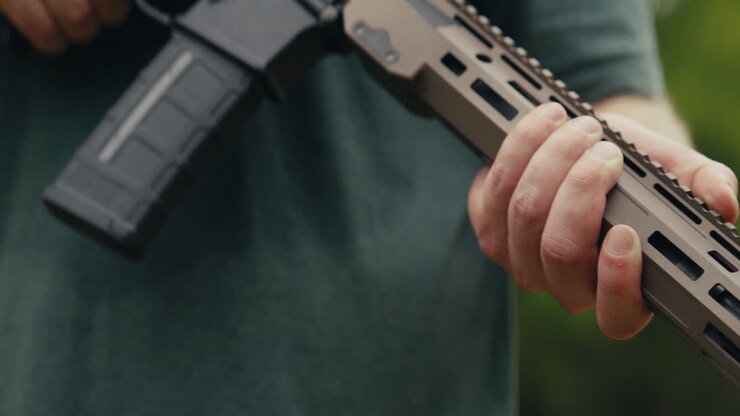 Man with rifle wearing protective gear