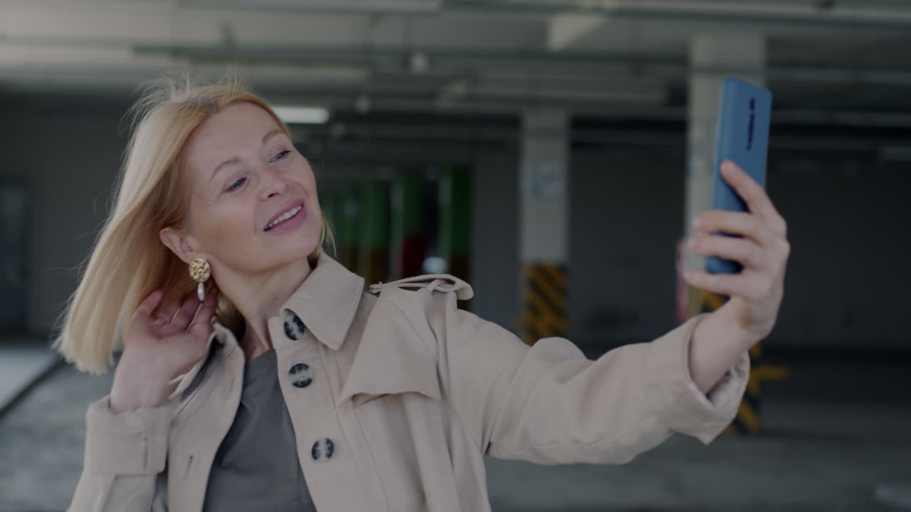 Woman taking a selfie in a parking garage