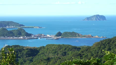 panoramic panning shot capturing the beautiful landscape of shen'ao fishing harbor and keelung islet from jiufen mountain town at daytime, ruifang district, new taipei city, taiwan