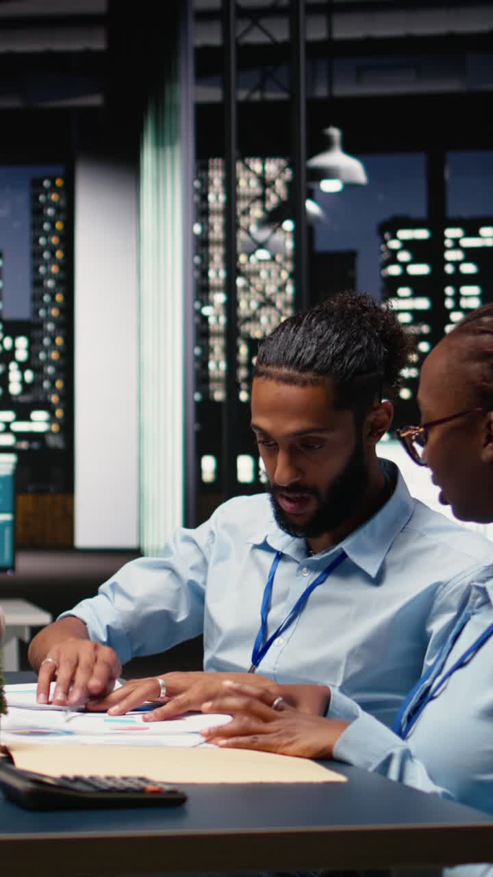 Vertical Video Multiethnic office coworkers reading emails on laptop in boardroom