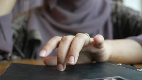 woman looking at a menu in a cafe