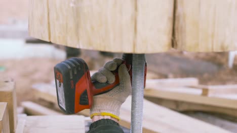 installing a wooden post with a drill